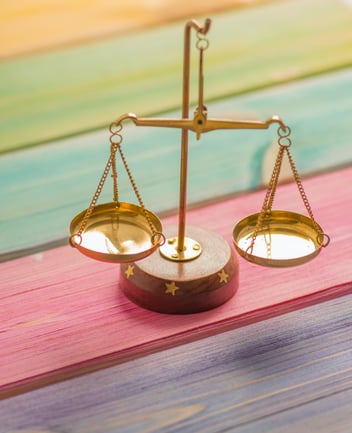 A gold scale on a multi-colored bench 