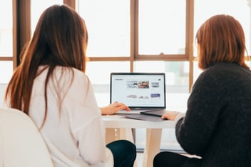 A mentor and mentee sitting at a desk