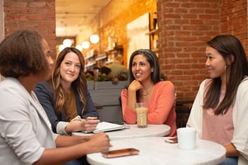 Women sitting around a table networking 