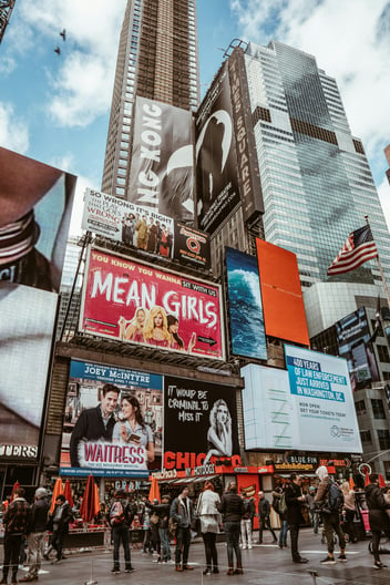 Billboard advertisements in the city, including Mean Girls on Broadway