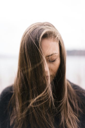 woman looking down with hair in face