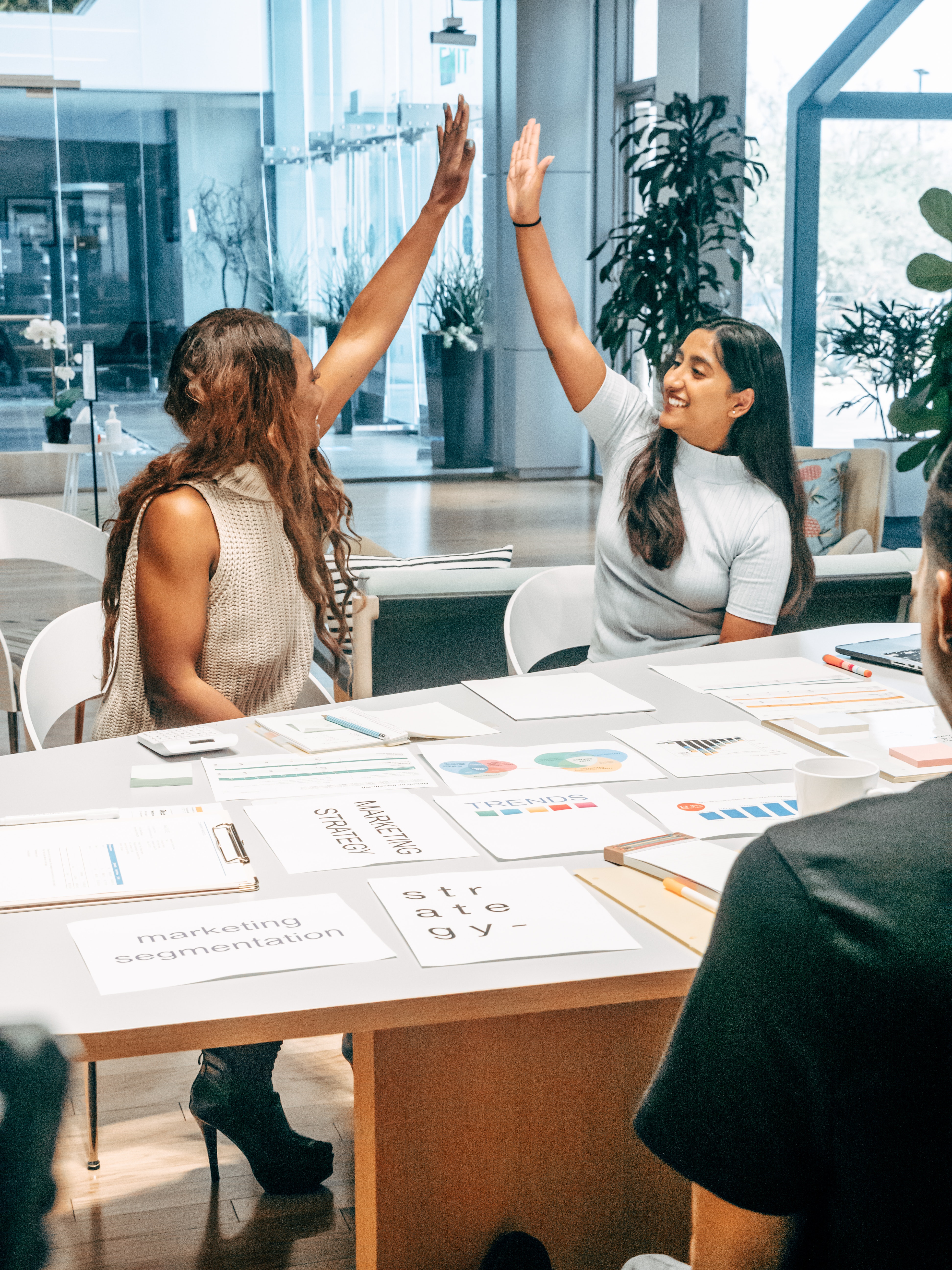 Women high five at the meeting.