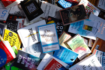 non-fiction books scattered in a pile 