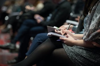 people sitting and taking notes 